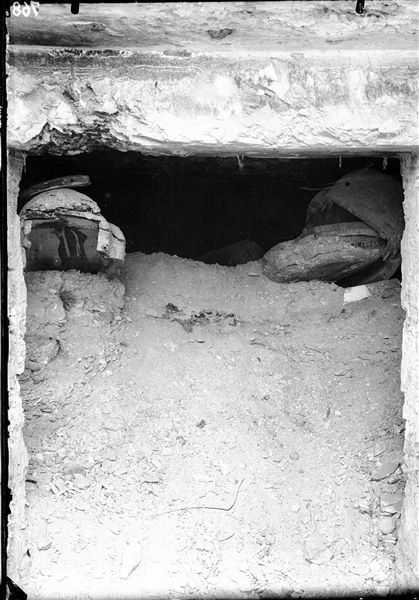 L’ingresso alla tomba del principe Sethherkhepeshef (QV43) al momento del rinvenimento, con il consistente deposito di schegge di calcare e sabbia progressivamente trasportato all’interno del passaggio da ripetuti episodi alluvionali. Sulla superficie superiore sono ben visibili resti di sarcofagi che potrebbero essere giunti anch’essi insieme ai depositi alluvionali, oppure (più probabilmente) derivare dal riutilizzo di questa tomba in epoche successive. Scavi Schiaparelli.