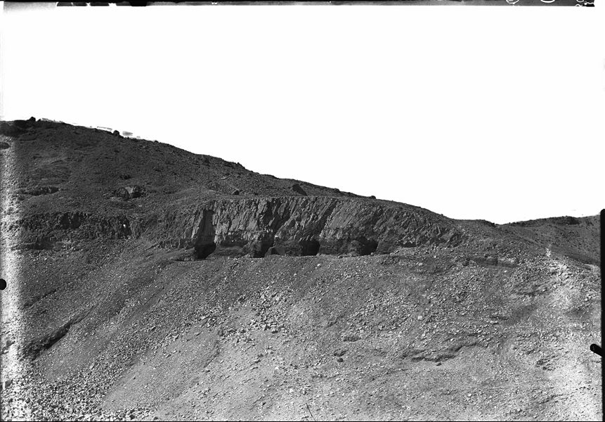 Results from the excavations in the small side valley where the tomb of Prince Ahmose (QV88) was found, as well as four other tombs whose entrances are visible side by side (Original label: at the end of the smaller valley after excavations). Schiaparelli excavations.