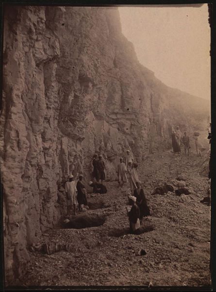 Excavating at the foot of a rock face of the Theban mountain, in a large valley adjacent to the Valley of the Queens. Schiaparelli excavations. 