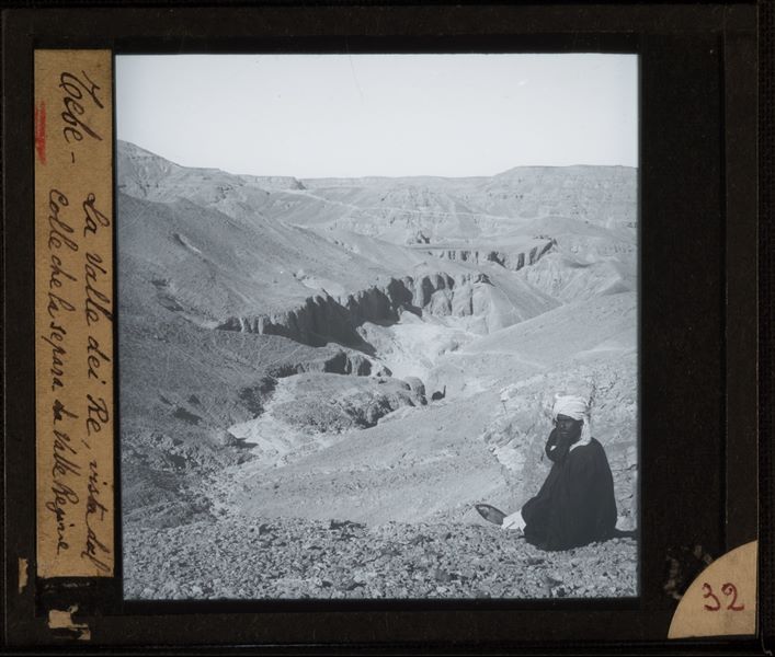 Man sitting on the hillside, which separates the Valley of the Queens from the Valley of the Kings.