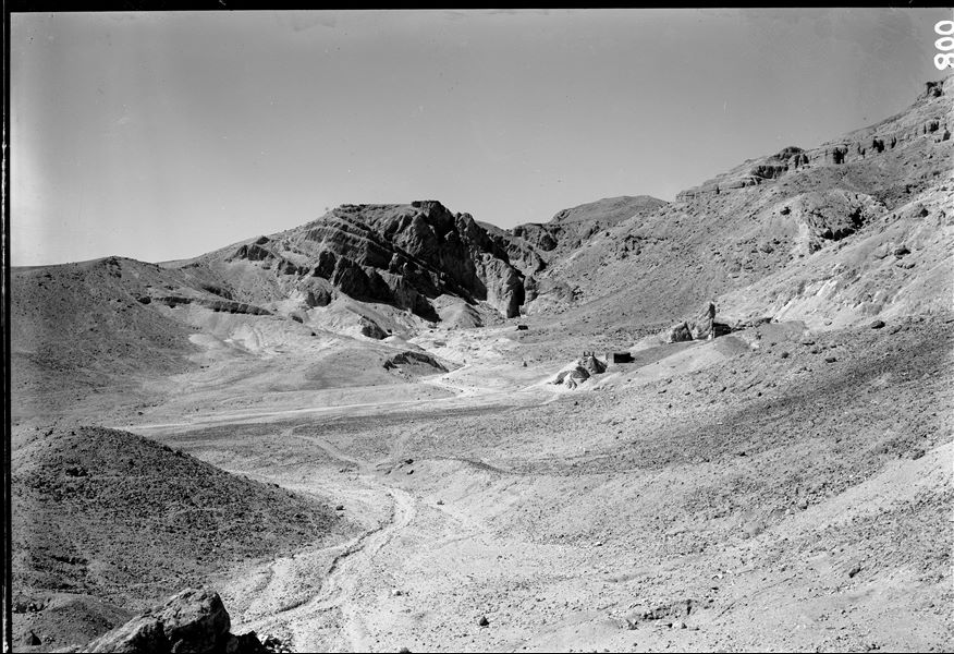 General view of the Valley of the Queens, on the left the so-called Valley of Prince Ahmose. In the foreground, the brick structure used by the Italian Archaeological Mission next to the remains of the Coptic monastery at Deir er-Rumi. Schiaparelli excavations.
