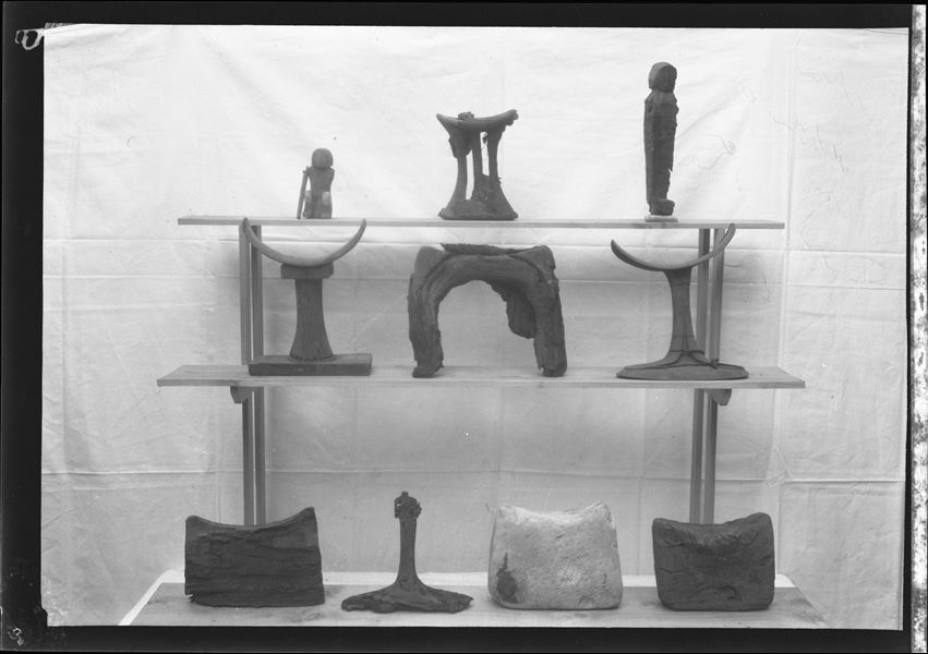Series of clay, wood and stone headrests photographed during excavations, probably traceable to the Farina excavations. 