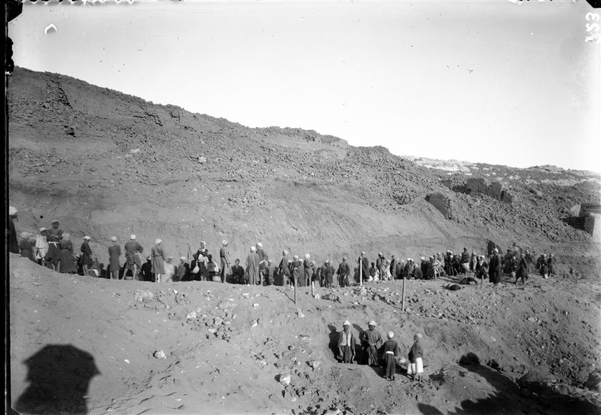 Excavations towards the top of the western side of the southern hill. Excavation works to recover structures buried by debris. In the centre, the posts driven into the ground indicate the presence of an underground structure being excavated by some workmen. Schiaparelli excavations. 