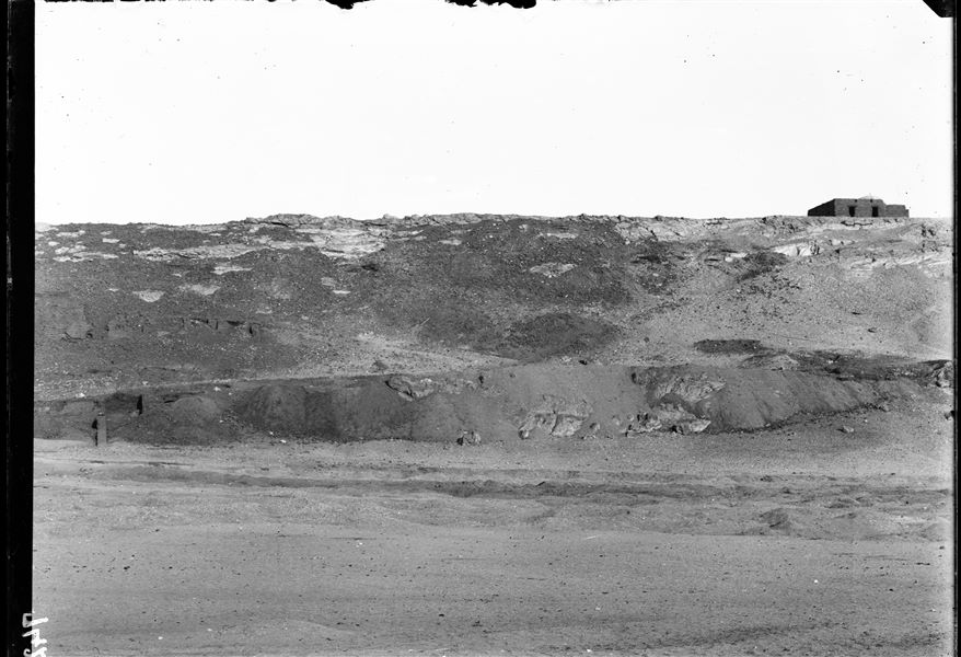 View of the hill with the tomb of the holy man Sheikh Musa. On the left, a small part of the impressive mud-brick structures that formed a vast fortified area, defending the northern part of the country. Schiaparelli excavations. 