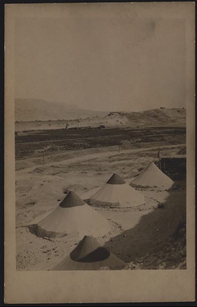 Gebelein archaeological site, camp of the Italian Mission directed by Ernesto Schiaparelli. The narrow-gauge railway for the transport of sugar cane is visible in the background, along with the southern hill and the tomb of the holy man Sheikh Musa. Schiaparelli excavations.