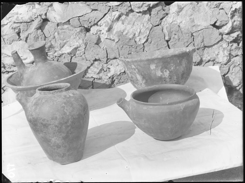 Tomb of the Unknown. Before being packed for transport, the objects were inventoried and photographed, often grouped together. Visible in the picture: a ewer and basin in terracotta (S.13957) ​​); two different vases with spouts (S.13956 and S.13955); and a vase with lime remains (S.13959). Schiaparelli excavations. 