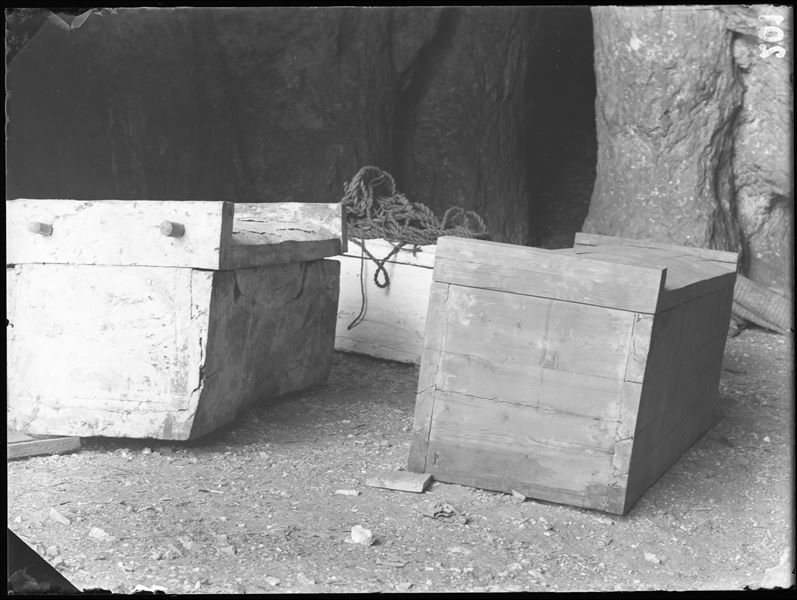 Tomb of the Unknown. The picture, taken in the large caves of the camp shortly after discovery, shows the coffin (S.13965) on the left which housed the mummy of the deceased. This coffin was placed inside the larger wooden one (S.13964). Schiaparelli excavations.  