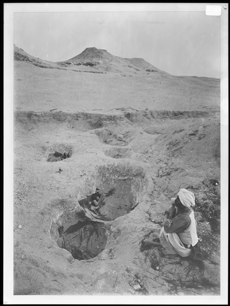 Northern necropolis. Burial pits, the remains of the mats that the deceased were wrapped in are visible. In one of the pits a terracotta model boat or granary can be seen. Farina excavations.