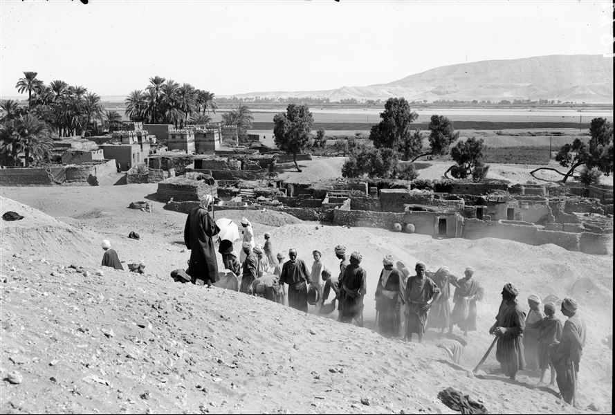 Excavations along the slope of the hill, west of the village of Abu Hummas. The Nile is visible on the horizon, and beyond is the mountain range of the Eastern Desert. Farina excavations. 
