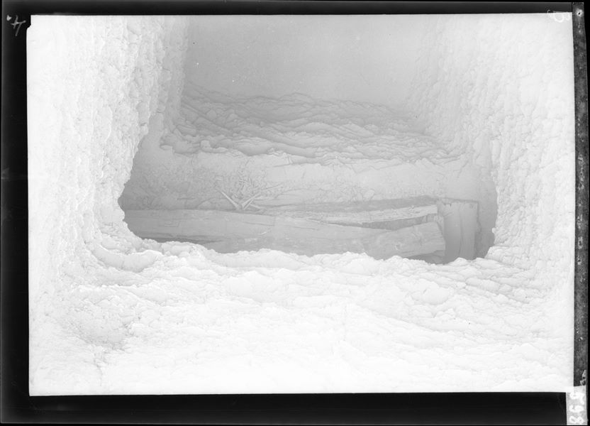 Entrance to a tomb at the time of discovery, the interior of the small room with its contents can be seen. The image was taken using magnesium flash photography. Probably from excavations in 1911 conducted by Virginio Rosa, a collaborator of Ernesto Schiaparelli. Schiaparelli excavations. 