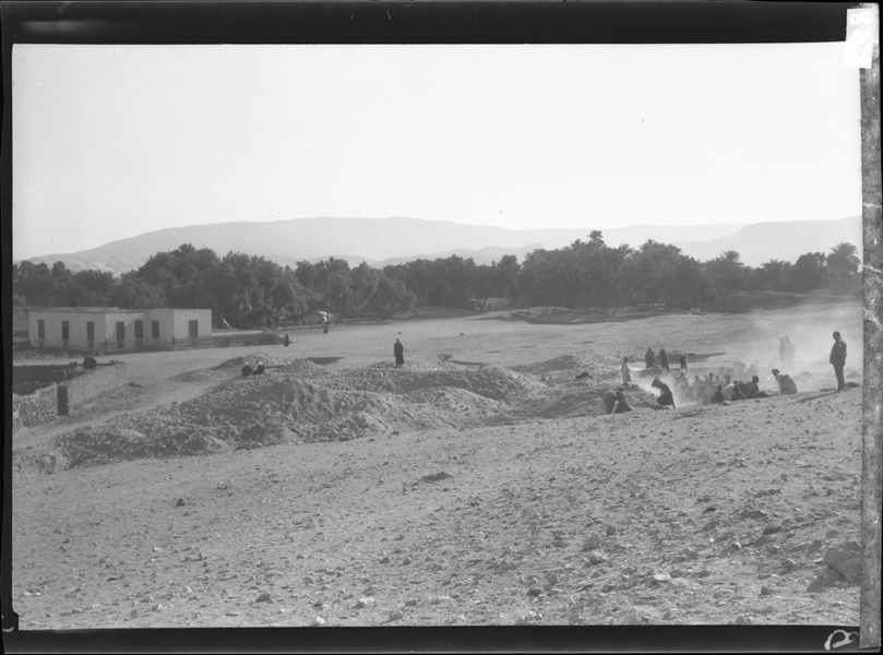 Excavating near the last section of houses from Abu Hummus. To the right of the modern house seen here, the camp’s tents are visible among the trees. (Still) on the right, Giovanni Marro is assisting with excavations. Farina excavations. 