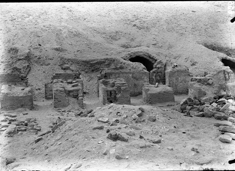 Tomb of Iti and Neferu before excavations began. View of the central part of the half rock-cut structure. The vault of the central chapel is visible, as well as some of the precious paintings that decorated the walls of the outer portico. On the pillar in the centre is one of the many funerary cones found in the tomb. This tomb of undoubted beauty, can be dated to the First Intermediate Period (2118 - 1980 B.C.E). Schiaparelli excavations.   