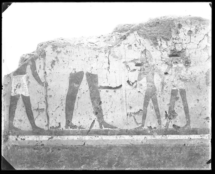 Tomb of Iti and Neferu. Pillar number 2. In the centre of the scene, the larger figure represents Iti, holding a bow. In front of him, a soldier presents a naked boy, perhaps a captive of war. Behind Iti, a man holds a pole covered with cowhide that probably held a banner. Schiaparelli excavations.