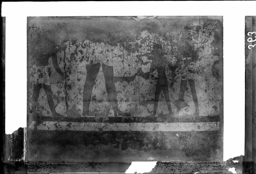 Tomb of Iti and Neferu. Museum display. Pillar number 2. In the centre of the scene, the larger figure represents Iti, holding a bow. In front of him, a soldier presents a naked boy, perhaps a captive of war. Behind Iti, a man holds a pole covered with cowhide that probably held a banner. Schiaparelli excavations.  (S.14354/04)