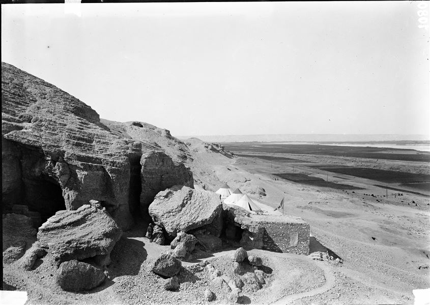 View from the first hill, beyond the camp. On the left are the large caves of the old stone quarry. On the right, the piling for the electrical telegraph system, often used by the mission for urgent communications. Schiaparelli excavations. 