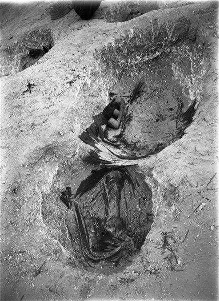 Northern necropolis. Burial pits, the remains of the mats which the dead were wrapped in are still visible. In one pit, a terracotta boat or granary model can be seen. Farina excavations. 