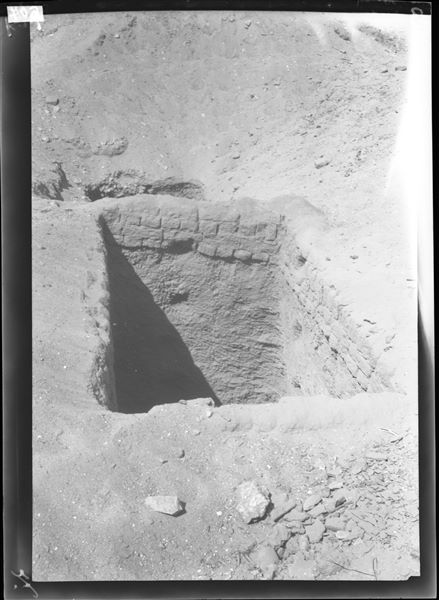 Excavating a second rectangular shaft, with the access bordered by mud- brick layers. Farina excavations. 