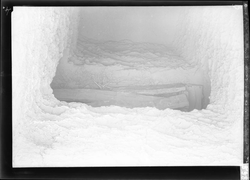 Entrance to a tomb at the time of discovery, the interior of the small room with its contents can be seen. The image was taken using magnesium flash photography. Probably from excavations in 1911 conducted by Virginio Rosa, a collaborator of Ernesto Schiaparelli. Schiaparelli excavations. 