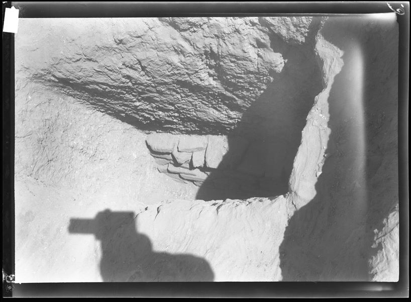 Northern necropolis. Access to a shaft dug in the rock. The wall of bricks and stones, which closes the passage to the burial chamber, is visible at the bottom. Farina excavations. 