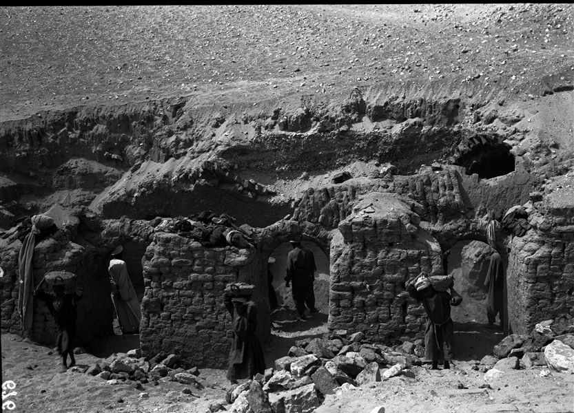 Mud-brick tomb with portico. Removal of sand from the structural remains, gradually bringing the architecture of the tomb to light. Schiaparelli excavations. 