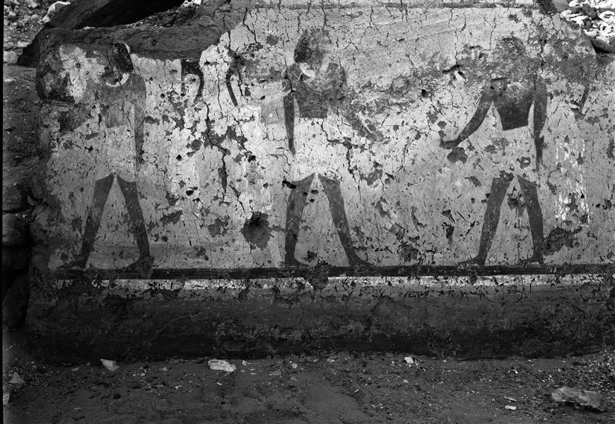 Tomb of Iti and Neferu. The painting depicts three male figures with short kilts, each accompanied by women wearing long white dresses. The central figure, with slightly larger proportions could possibly be Iti. For unknown reasons this painting did not reach Turin, perhaps it was damaged during its detachment. In addition to this image, there are notes from Virginio Rosa, placing the painting on the stretch of wall between the eighth and ninth rooms. Schiaparelli excavations.