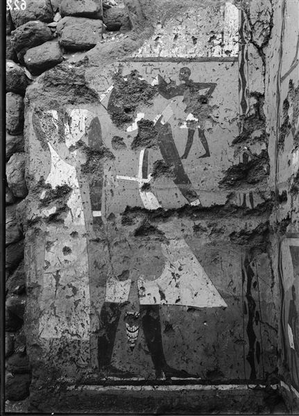 Tomb of Iti and Neferu. While excavating the tomb, precious tempera paintings were brought to light. In addition to their funerary context, they also document tasteful scenes related to daily life in an agricultural setting. The photograph shows the back wall, right side of the deceased’s cult chapel, depicting the couple in an affectionate pose dressed in white ceremonial clothes. Schiaparelli excavations.