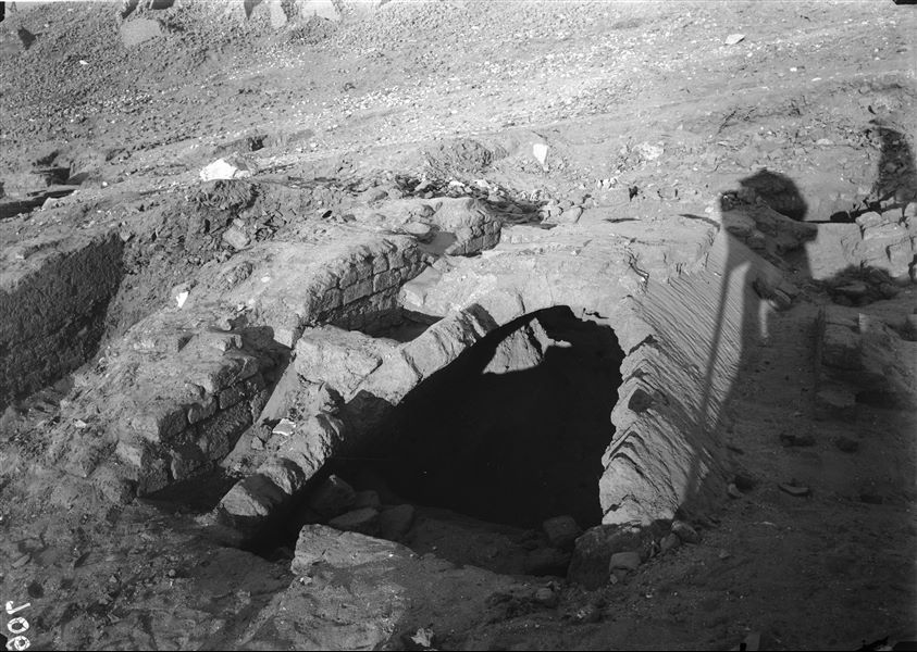 Excavations at the foot of the southern hill, western side. Remains of mud-brick structures with a barrel vault. The shadow of Ernesto Schiaparelli is projected on the ground whilst taking the photo. Schiaparelli excavations.  