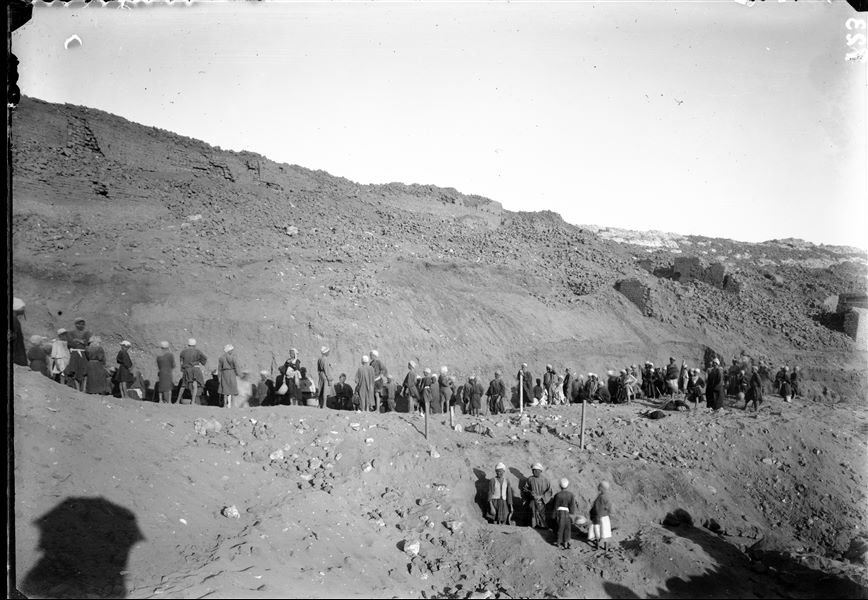 Excavations towards the top of the western side of the southern hill. Excavation works to recover structures buried by debris. In the centre, the posts driven into the ground indicate the presence of an underground structure being excavated by some workmen. Schiaparelli excavations. 