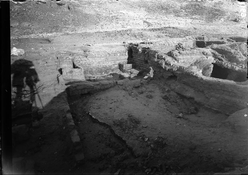 Excavations at the foot of the southern hill, western side. Remains of mud-brick structures with a barrel vault. The shadow of Ernesto Schiaparelli is projected on the ground whilst taking the photo. Schiaparelli excavations.  