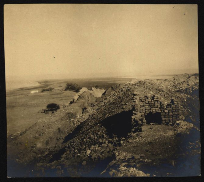 Southern hilltop where the fortress and temple dedicated to the goddess Hathor stood. In the foreground, a pile of ancient bricks from the excavation. Visible on the left, the northern part of the first hill. Schiaparelli excavations.