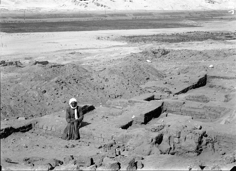 Southern hill, western side, plain from the area below the hill. Remains of significant mud-brick structures, prior to the start of excavations. Visible in the background, beyond the telegraph line is the northern hill. Schiaparelli excavations. 