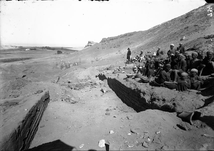 Southern hill, western side. Excavations among the impressive mud-brick structures at the foot of the fortress. The person with coat and hat is the same individual in picture C00634. Schiaparelli excavations. 