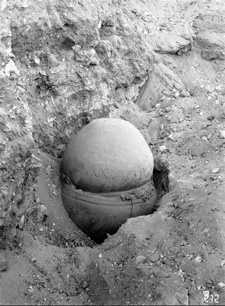 Scattered burials on the eastern slopes of the north hill. A burial in a double vase, the lower half contained the skeletal remains while the upper half functioned as a lid. Often the two vessels were sealed together with mud mortar. Schiaparelli excavations. (S.15741) 