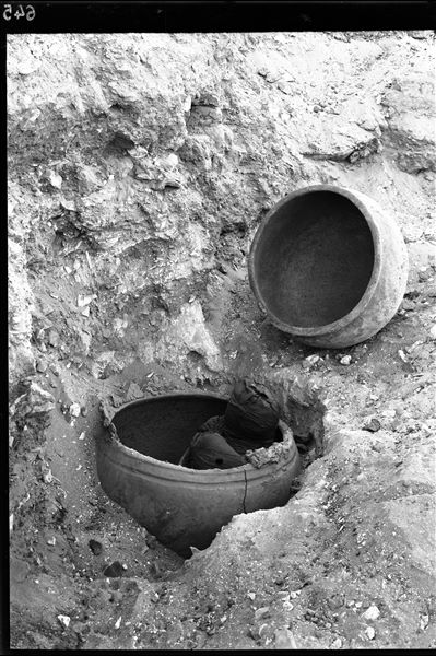 Scattered burials on the eastern slopes of the north hill. A burial in a double vase; the one shown  C00635. The lower half of the vase contained skeletal remains, here wrapped in cloth. The upper half functioned as a lid. Often the two vessels were sealed together with mud mortar. Schiaparelli excavations. (S.15741) 