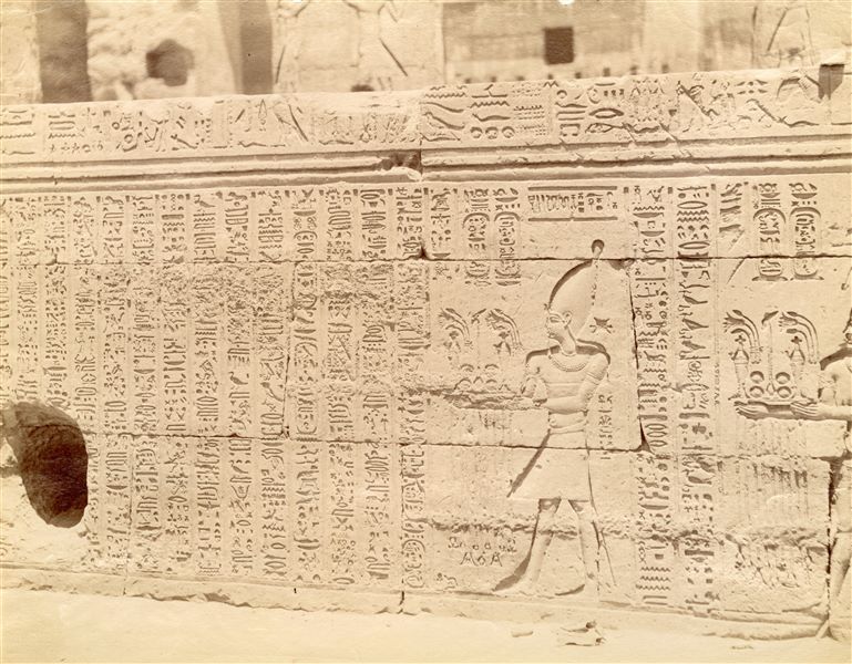 L'immagine mostra una parte dei testi e delle scene che decorano la parete esterna dell'atrio colonnato (ipostilo) del tempio di Sobek e Haroeris a Kom Ombo. 