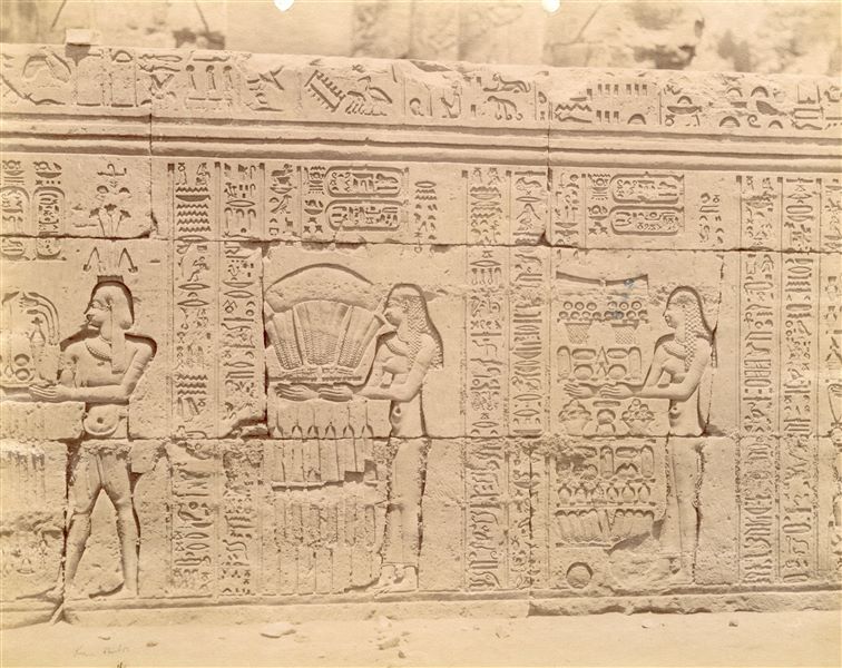 The photograph shows part of the texts and sacred scenes on the exterior wall of the hypostyle hall from the Temple of Sobek and Haroeris at Kom Ombo. 