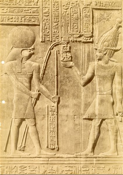 The image shows a close-up of a sacred scene from the interior walls of the Temple of Sobek and Haroeris at Kom Ombo. 