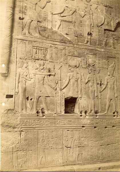 The photograph shows some texts and scenes from the walls of The temple of Sobek and Haroeris at Kom Ombo, where the pharaoh stands before some deities. 