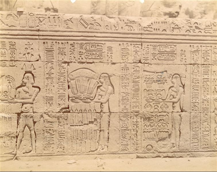 The photograph shows part of the texts and sacred scenes on the exterior wall of the hypostyle hall from the Temple of Sobek and Haroeris at Kom Ombo. 