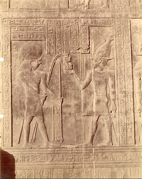 The photograph shows a sacred scene between the god Horus and Pharaoh Ptolemy VIII, from the walls of the Temple of Sobek and Haroeris at Kom Ombo. 