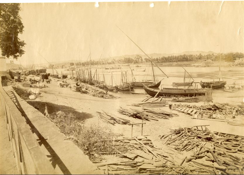 The photograph shows carpenters at work on boats on the banks of the Nile, near Aswan and the Elephantine Island. Due to the length of the camera exposure, the carpenters are blurred. 