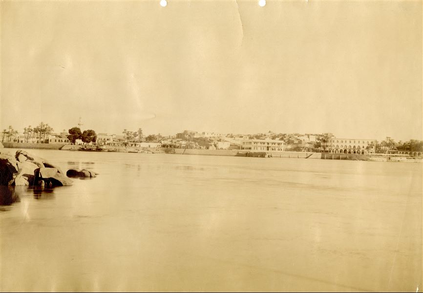 The photograph shows a panorama of the 19th century village of Aswan, photographed from the west bank of the Nile. 
