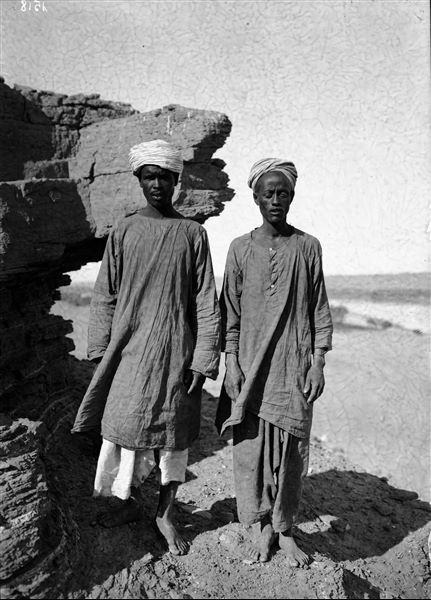 Egyptian couple photographed presumably near Qubbet el-Hawa, in the background, the Nile. Schiaparelli excavations. 