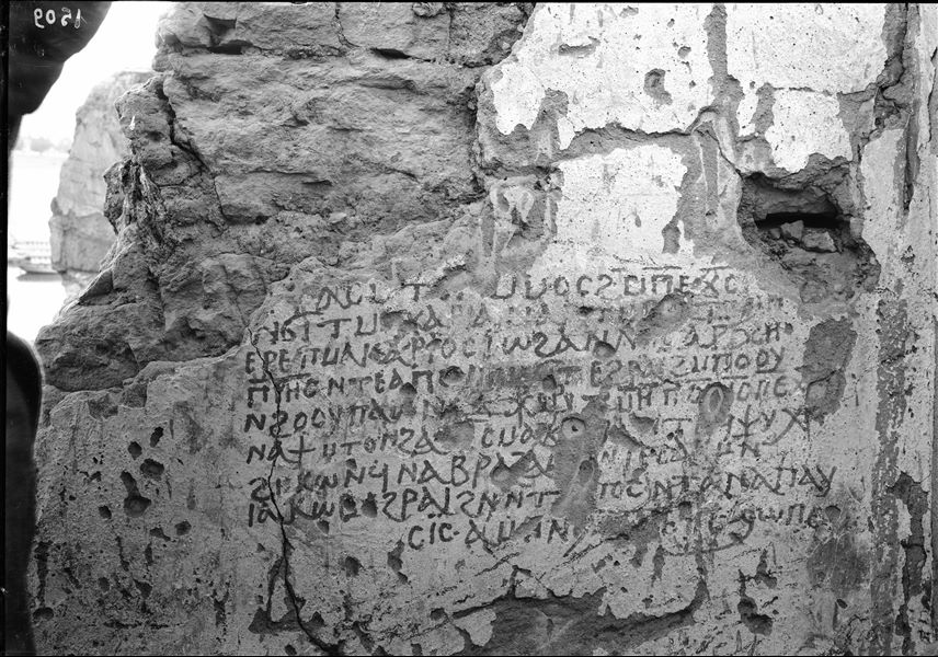 Coptic inscription photographed in Qubbet el-Hawa, in the background, the Nile and a boat. Schiaparelli excavations. 
