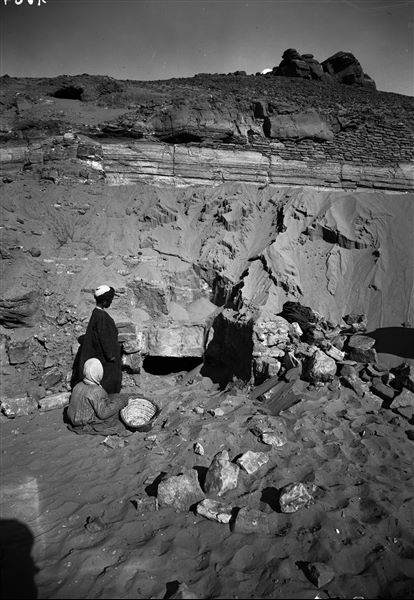 Excavating the rock-cut tombs of Qubbet el-Hawa. At the top, the dome of the tomb of sheik el-Hawa can be seen. Schiaparelli excavations.