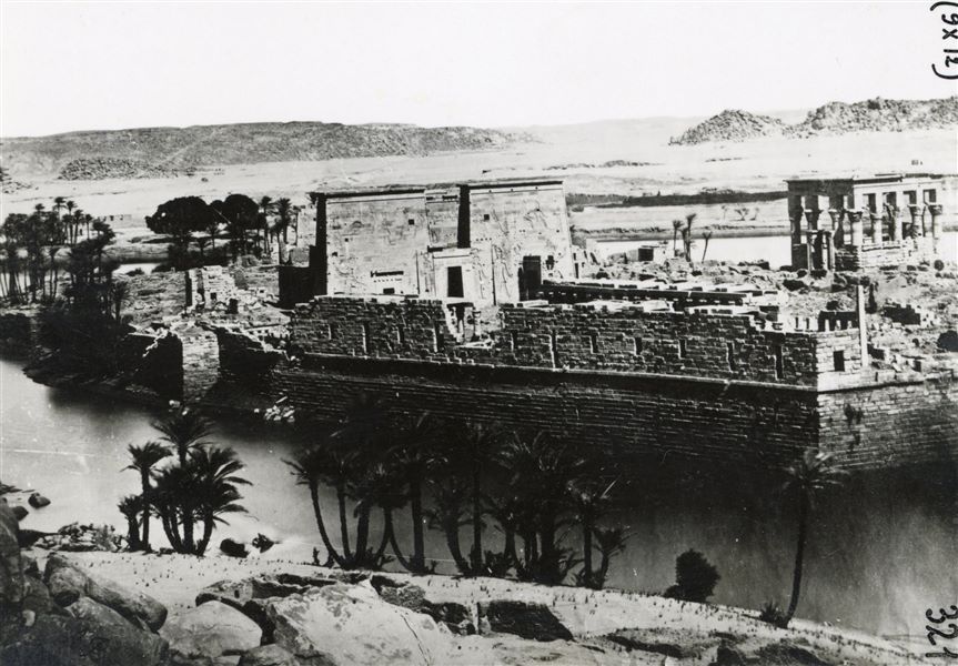 Overview of the Temple of Isis on the island of Philae, taken from the nearby island of Bigeh. Clearly visible are Trajan’s Kiosk (on the right) and the first pylon which provides access to the temple (in the centre). 