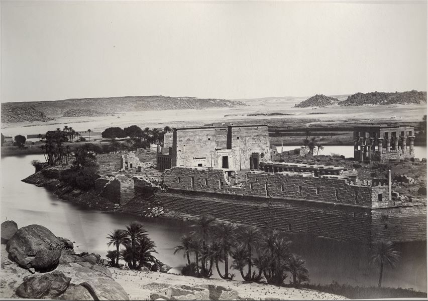 View of the island of Philae, where there is the temple complex dedicated to the goddess Isis. In the photograph the first pylon of the temple in the centre is clearly visible (behind this, the second pylon can be glimpsed), and on the right is Trajan’s Kiosk. The author's signature is visible at the bottom left.