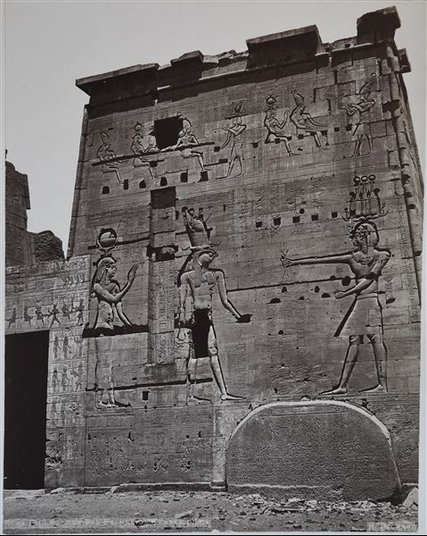 Detail of the front façade, right side, from the second pylon of the Temple of Isis on the island of Philae. Pharaoh Ptolemy XII is represented making offerings to Horus and Isis. The author's signature is visible on the bottom right. 