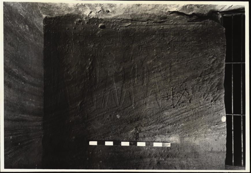 Photograph of a wall from the rock-cut chapel of Ellesiya in its original location in Nubia, shortly before the Nile waters would begin to rise due to the construction of the Aswan Dam, which would flood the area. Photograph taken in the mid-1960s, shortly before the rock-cut chapel was moved.