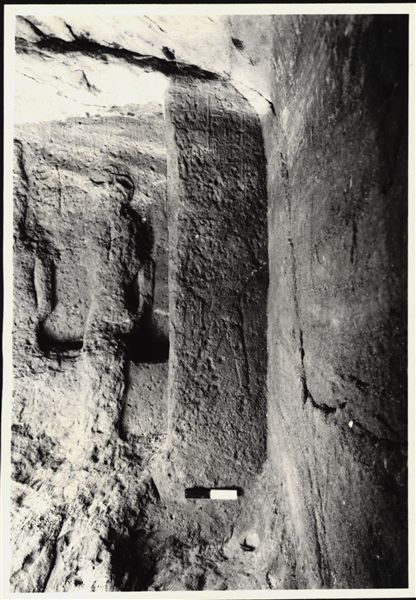 Photograph of the back niche in the rock-cut chapel of Ellesiya, where the statues of deities and the pharaoh were located. The rock-cut chapel is in its original location in Nubia, shortly before the Nile waters would begin to rise due to the construction of the Aswan Dam, which would flood the area. Photograph taken in the mid-1960s, shortly before the rock-cut chapel was moved. Note the original floor, which was not saved.